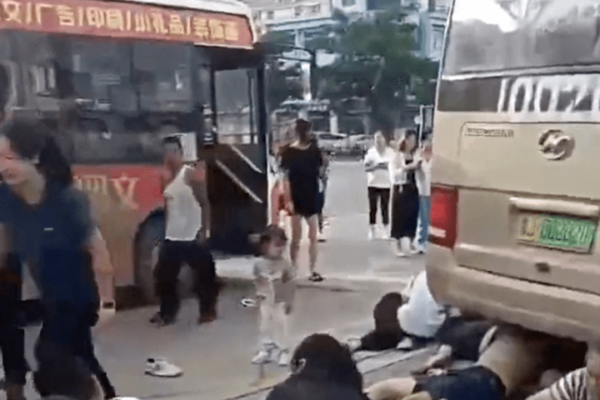 A school bus ploughed into a crowd of people outside a middle school in eastern China on Tuesday, killing 11 parents and students, state media reported.